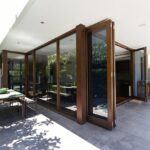 About bi fold doors opening to rear courtyard of contemporary australian home